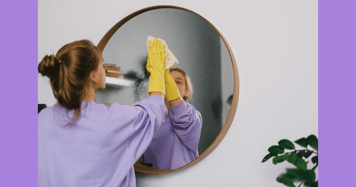 housekeeper cleaning and shining the mirror