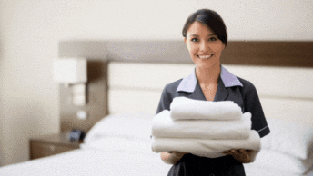 housekeepers folding towels in a hotel